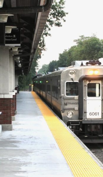 An NJ Transit message board (upper left) displays an ad as a Hoboken-bound train arrives in Ridgewood, N.J. in August 2019. NJ Transit is seeking information on systems to update and unify its real-time information for customers. (David Lassen / Trains Pro)
